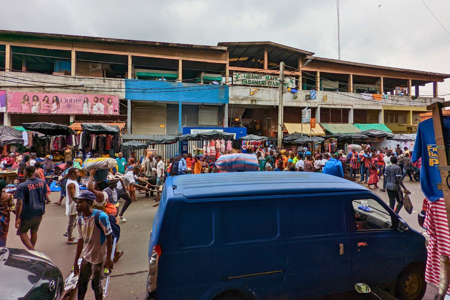 A two-story market building in Abidjan viewed from the across street